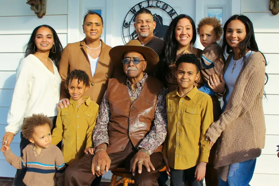 A great-grandad seated among his family